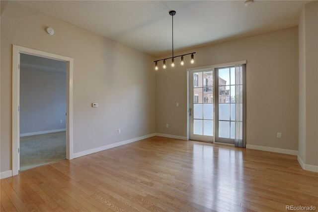 empty room featuring light wood-style flooring and baseboards