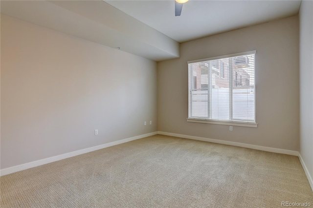 unfurnished room with light carpet, ceiling fan, and baseboards