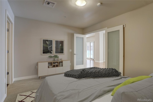 bedroom featuring carpet flooring, visible vents, and baseboards