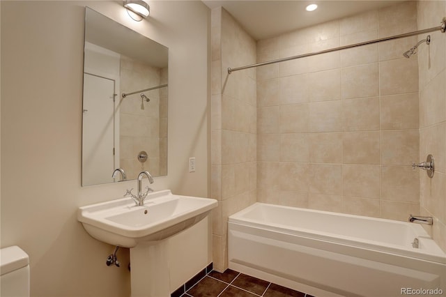 bathroom with a sink, bathtub / shower combination, tile patterned flooring, and toilet