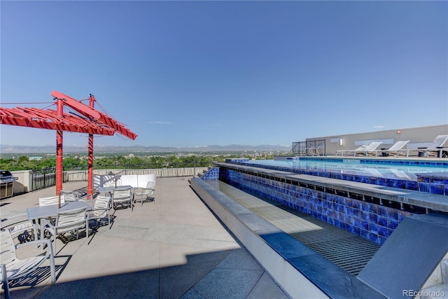 exterior space featuring a fenced in pool, a patio area, and fence