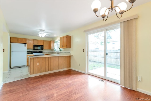 19421 E Milan Cir, Aurora, CO 80013 - kitchen featuring freestanding refrigerator, black microwave, electric stove, and a chandelier
