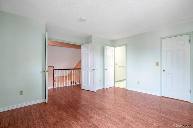 19421 E Milan Cir, Aurora, CO 80013 - empty room featuring wood finished floors, baseboards, and a textured ceiling