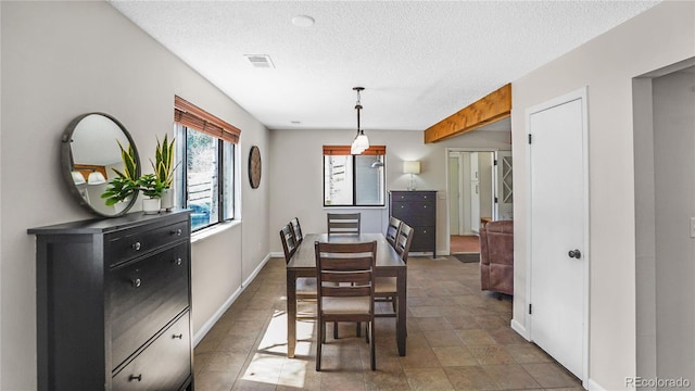 dining space featuring a textured ceiling