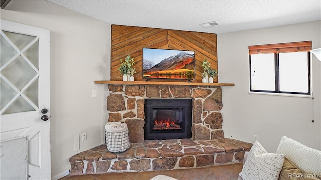 living room featuring a fireplace and a textured ceiling