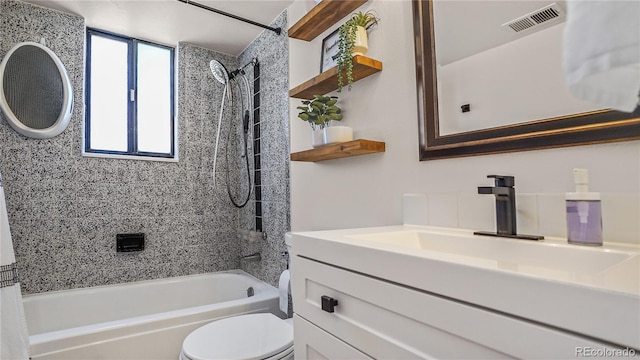 full bathroom featuring vanity, toilet, and tiled shower / bath