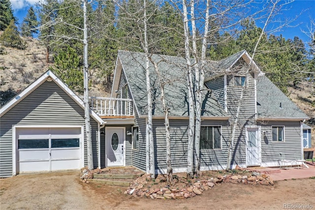 view of front of property with a garage and a balcony