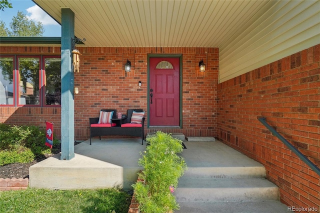 view of exterior entry featuring covered porch