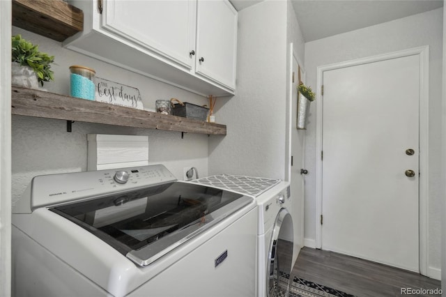 washroom featuring cabinets, dark wood-type flooring, and washer and dryer