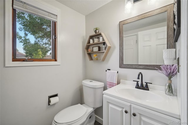 bathroom featuring vanity, toilet, and a textured ceiling