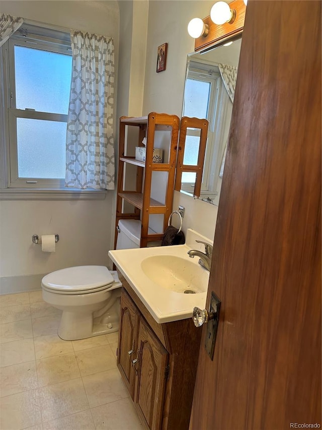 half bathroom featuring toilet and vanity