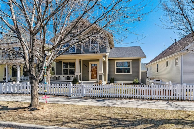 view of front of property with a fenced front yard and a porch