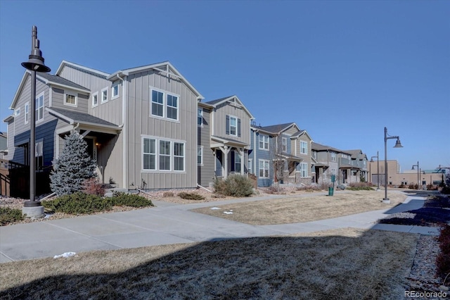 multi unit property featuring board and batten siding and a residential view