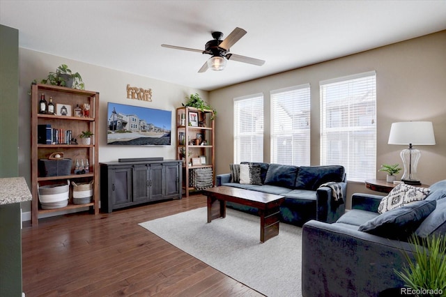 living room featuring dark wood-style floors and a ceiling fan