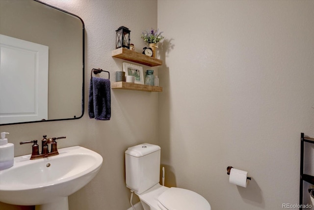 bathroom with toilet and a sink