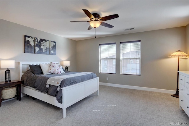 bedroom featuring light carpet, a ceiling fan, visible vents, and baseboards