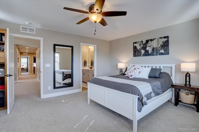 bedroom featuring light colored carpet, visible vents, a ceiling fan, connected bathroom, and baseboards