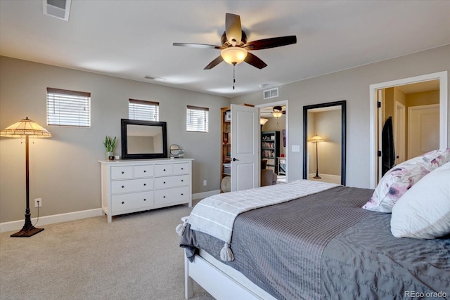 bedroom featuring light carpet, multiple windows, and visible vents