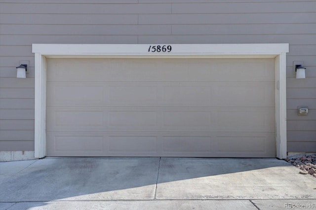 garage featuring concrete driveway