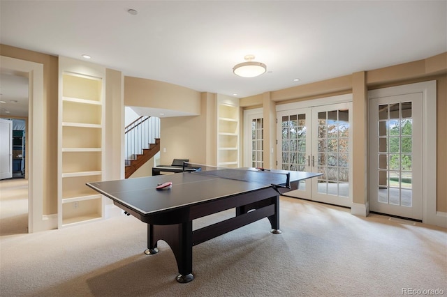 67 Indigo Way, Castle Rock, CO 80108 - recreation room with french doors, light colored carpet, built in features, and baseboards
