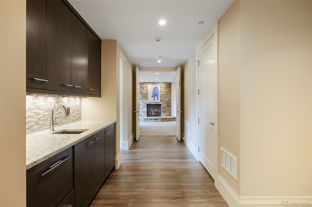 67 Indigo Way, Castle Rock, CO 80108 - hallway featuring a sink, light wood-style floors, baseboards, and recessed lighting
