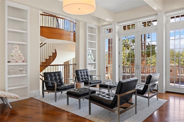 67 Indigo Way, Castle Rock, CO 80108 - living area featuring built in shelves, wood finished floors, and stairway