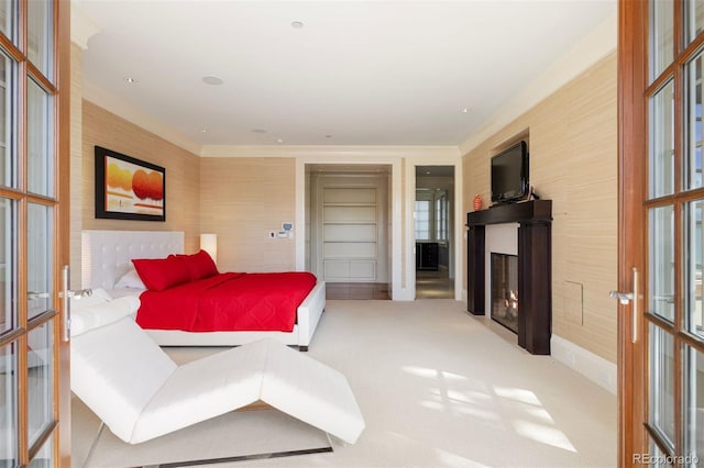 67 Indigo Way, Castle Rock, CO 80108 - bedroom featuring french doors, a glass covered fireplace, and carpet flooring
