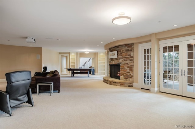 67 Indigo Way, Castle Rock, CO 80108 - living room with light carpet, french doors, built in features, stairs, and a fireplace