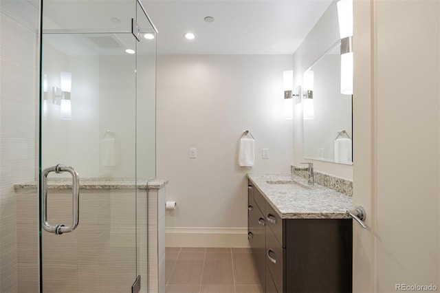 67 Indigo Way, Castle Rock, CO 80108 - full bath with vanity, a shower stall, baseboards, tile patterned floors, and recessed lighting