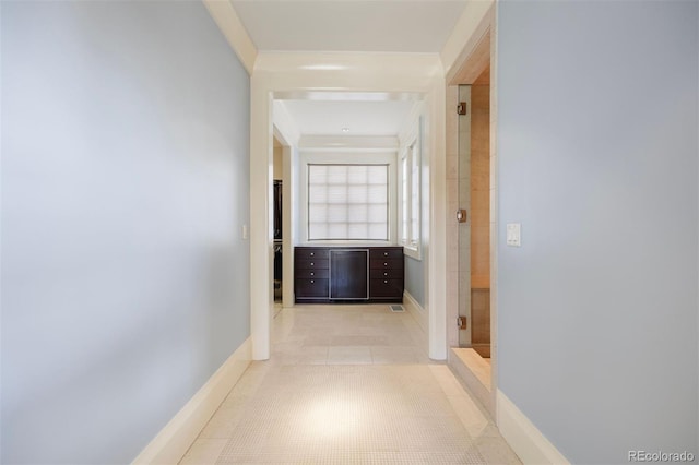 67 Indigo Way, Castle Rock, CO 80108 - hallway with crown molding, baseboards, and light tile patterned flooring
