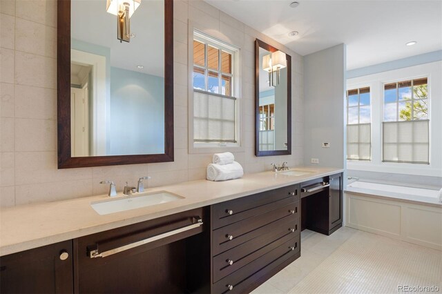 67 Indigo Way, Castle Rock, CO 80108 - full bathroom featuring double vanity, a garden tub, tasteful backsplash, and tile patterned flooring
