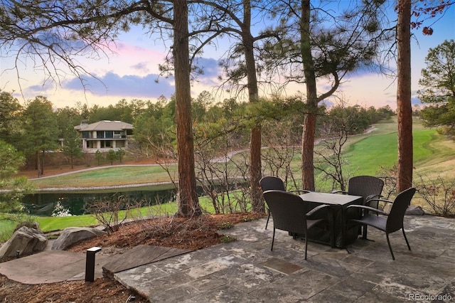 67 Indigo Way, Castle Rock, CO 80108 - patio terrace at dusk with a patio area, a lawn, and outdoor dining space