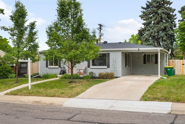 5740 S Cherokee St, Littleton, CO 80120 - view of front of home with concrete driveway, an attached carport, and brick siding