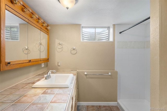 5740 S Cherokee St, Littleton, CO 80120 - bathroom featuring vanity and tiled shower