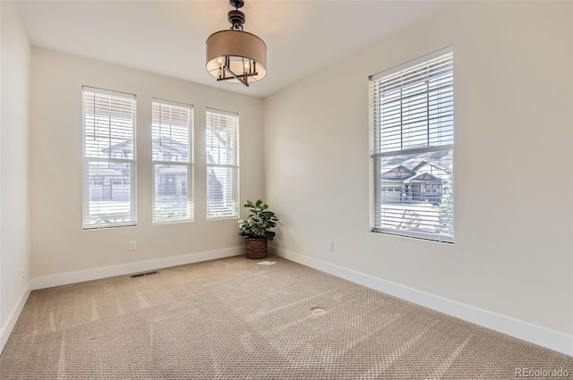 15705 Red Deer Dr, Morrison, CO 80465 - carpeted empty room featuring visible vents, baseboards, and an inviting chandelier