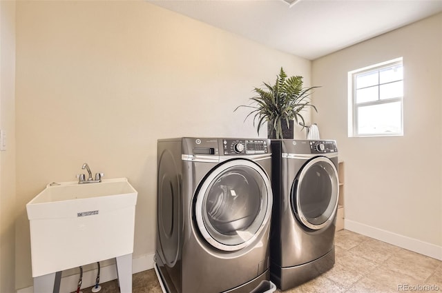 15705 Red Deer Dr, Morrison, CO 80465 - laundry room featuring washer and clothes dryer, baseboards, laundry area, and a sink
