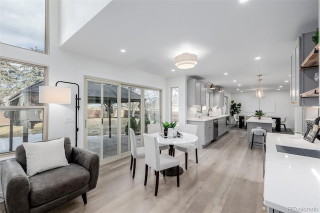 dining space featuring sink and light hardwood / wood-style floors