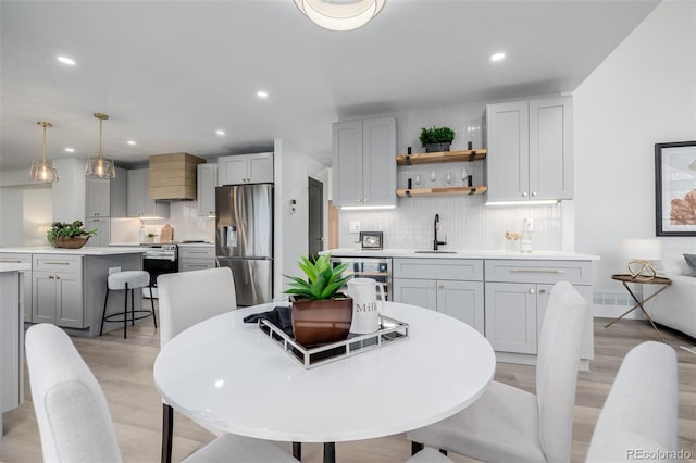 dining area featuring light hardwood / wood-style floors and sink