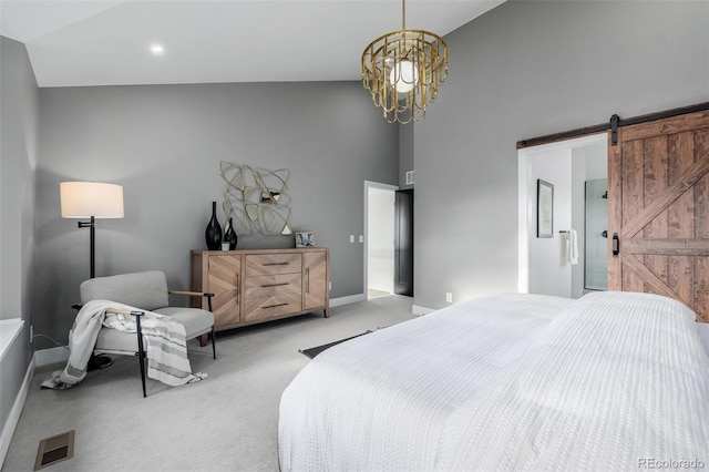 bedroom with a barn door, light carpet, a notable chandelier, and high vaulted ceiling