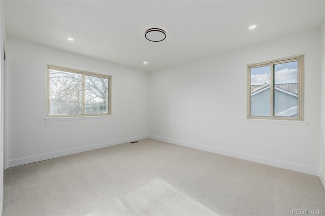 empty room featuring light colored carpet