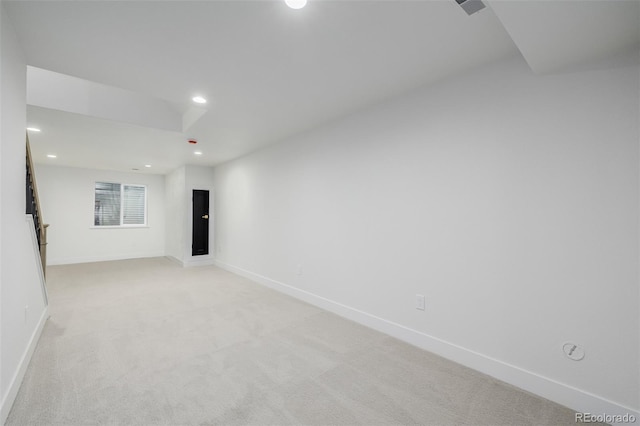 unfurnished room featuring light carpet