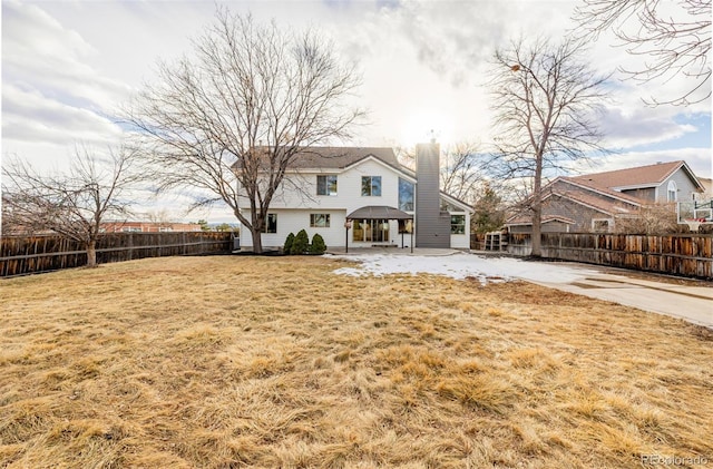 rear view of property with a lawn