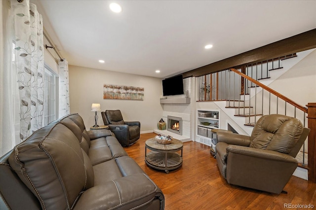 6936 S Knolls Way, Centennial, CO 80122 - living area with recessed lighting, baseboards, wood finished floors, a lit fireplace, and stairs