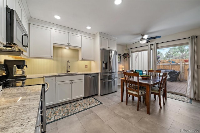 6936 S Knolls Way, Centennial, CO 80122 - kitchen with stainless steel appliances, a sink, ceiling fan, light countertops, and white cabinets