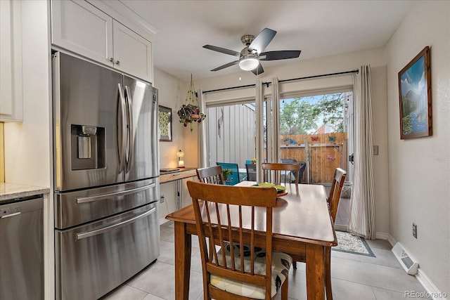 6936 S Knolls Way, Centennial, CO 80122 - dining area with light tile patterned floors, ceiling fan, and baseboards