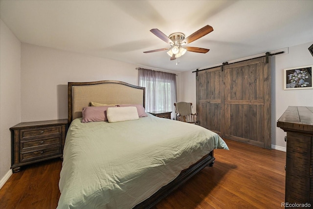 6936 S Knolls Way, Centennial, CO 80122 - bedroom featuring baseboards, a barn door, wood finished floors, and a ceiling fan