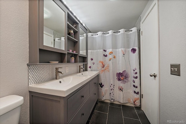 6936 S Knolls Way, Centennial, CO 80122 - full bathroom featuring a textured wall, toilet, tile patterned flooring, double vanity, and a shower with curtain