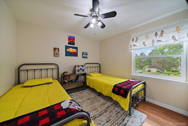 6936 S Knolls Way, Centennial, CO 80122 - bedroom with wood finished floors, baseboards, and ceiling fan