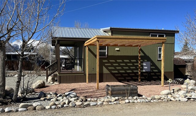 view of front of property with a deck and a pergola