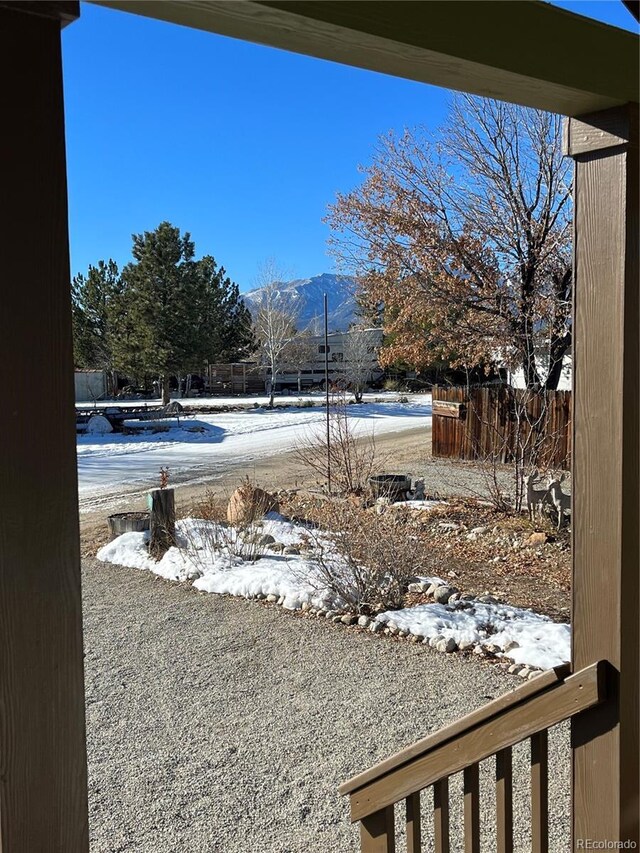 snowy yard featuring a mountain view